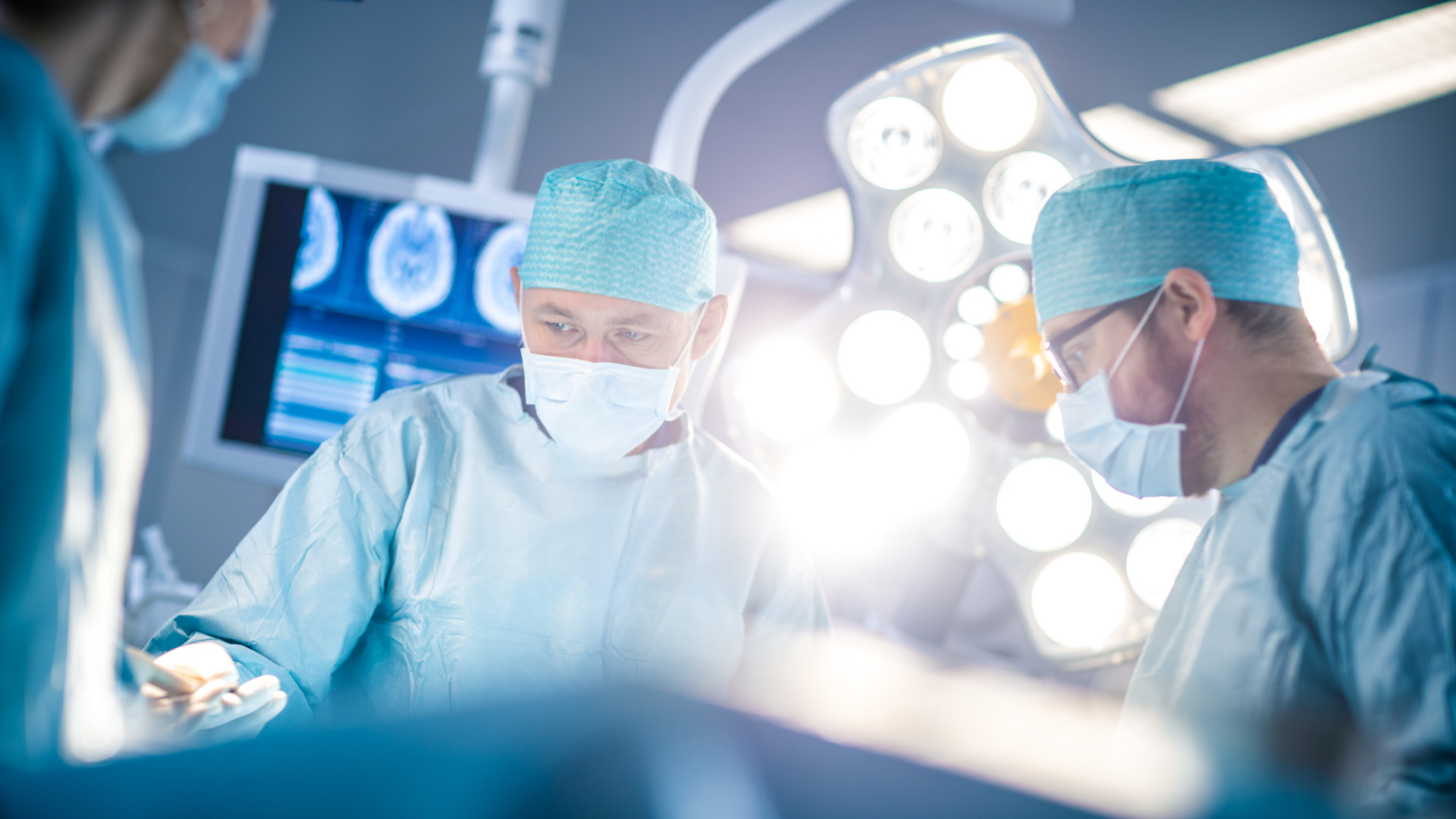 Low,Angle,Shot,In,The,Operating,Room,,Assistant,Hands,Out